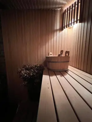 a bathroom with a tub sitting on a wooden deck at Kumpuolis LakeHouse in Degučiai