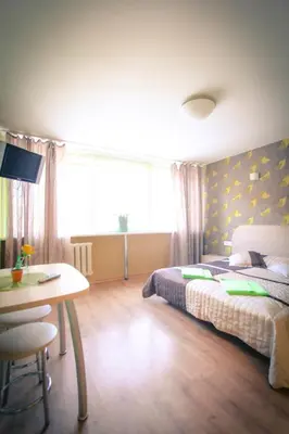 a bedroom with a bed and a desk and a table at Silvana in Vilnius
