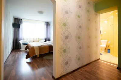 a bedroom with a bed and a bathroom at Silvana in Vilnius
