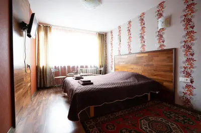 a bedroom with a bed and a large window at Silvana in Vilnius