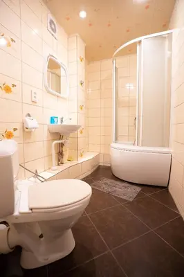 a bathroom with a toilet and a tub and a sink at Silvana in Vilnius