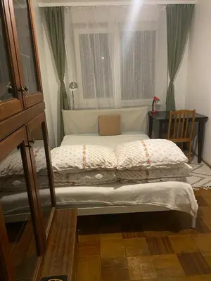 a small bed in a room with a window at Įdomus būstas ant Neries skardžio in Vilnius