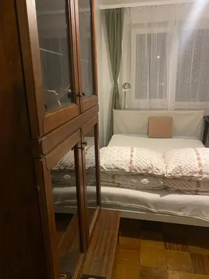 a small bedroom with a bed and a window at Įdomus būstas ant Neries skardžio in Vilnius