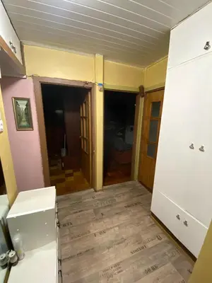 an empty room with a kitchen and a floor at Įdomus būstas ant Neries skardžio in Vilnius