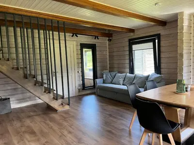 a living room with a couch and a table at Rubikių Meldynas Anykščiai in Anykščiai