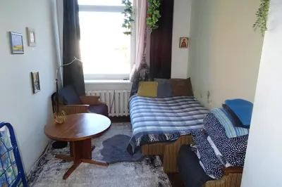 a small living room with a couch and a table at Studija virš cukrainės Druskininkuose in Druskininkai
