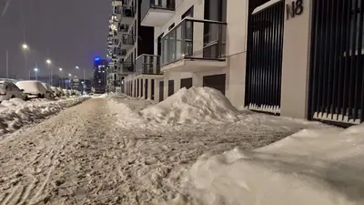 a pile of snow on the side of a street at Brand New and Modern 1BDR Apartment in Vilnius