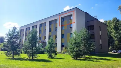 a building with trees in front of it at Dabintos Apartament Druskininkai in Druskininkai