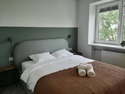 a bedroom with a bed with a pair of shoes on it at Hill Top apartment in central Kedainiai in Kėdainiai