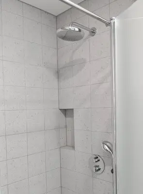 a bathroom with a shower with a glass door at Hill Top apartment in central Kedainiai in Kėdainiai