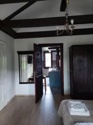 a room with a bed and a mirror and a bathroom at Quiet place in Kaunas