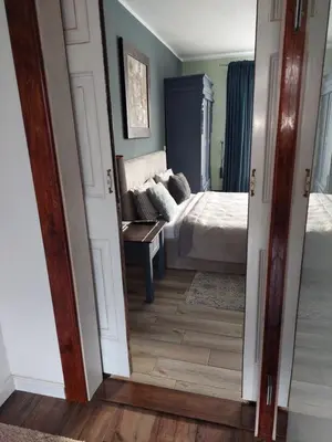 a room with a bedroom with a bed and a mirror at Quiet place in Kaunas