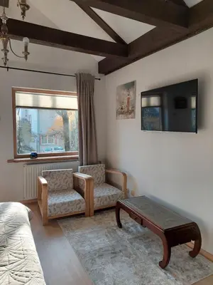 a living room with a couch and a table and a tv at Quiet place in Kaunas