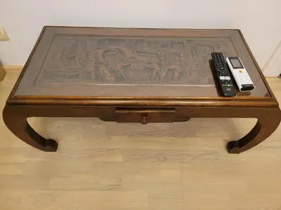 a wooden table with two remote controls on top of it at Quiet place in Kaunas