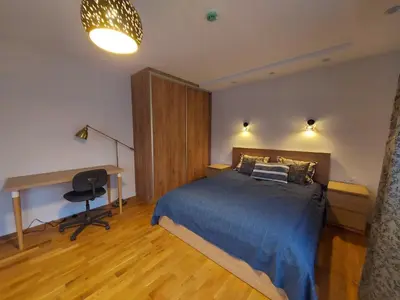 a bedroom with a bed and a desk in it at Gelvadiskes Forest in Vilnius