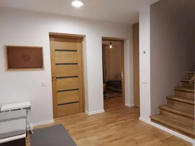 a hallway with stairs and a door in a house at Gelvadiskes Forest in Vilnius