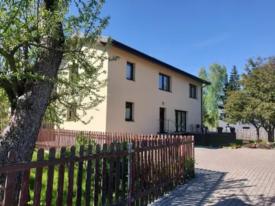 a white house with a fence and a tree at Gelvadiskes Forest in Vilnius