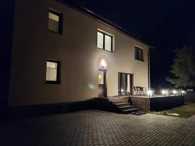 a building with lights on the side of it at night at Gelvadiskes Forest in Vilnius