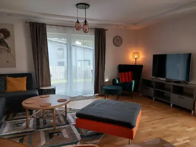 a living room with a couch and a tv at Gelvadiskes Forest in Vilnius