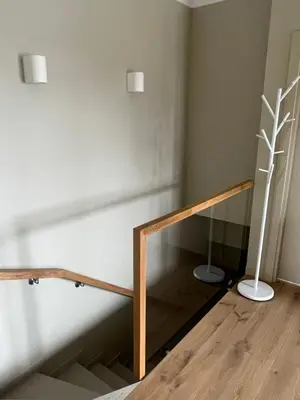 a room with a staircase with a vase on the floor at Apartamentai Muziejaus g. in Birštonas