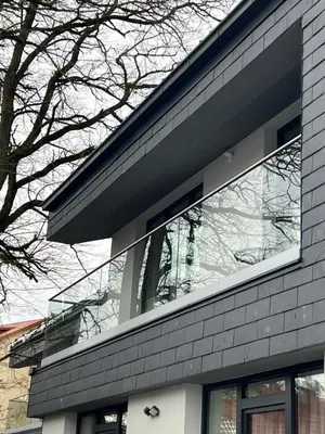 a glass facade of a building with a tree at Apartamentai Muziejaus g. in Birštonas