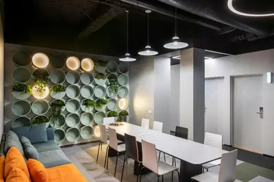 a dining room with a table and chairs and a wall of plates at Youston self check-in coliving Vilnius in Vilnius