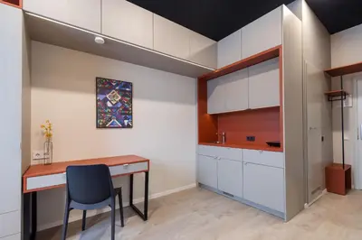 a kitchen with a table and a blue chair at Youston self check-in coliving Vilnius in Vilnius