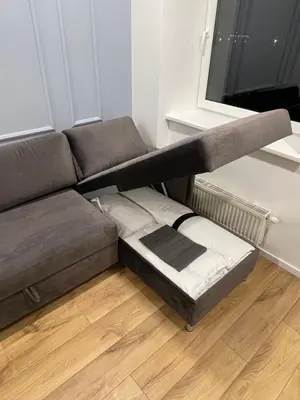 a couch with a bed underneath a window at 16 Airport Apartment in Vilnius