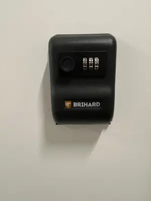 a black electrical outlet on a white wall at 16 Airport Apartment in Vilnius