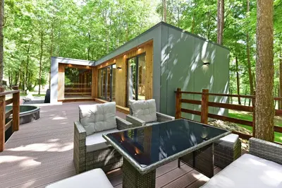a tiny house in the woods with a table and chairs at Forest relax in Svedai