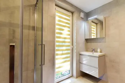 a bathroom with a shower and a sink and a mirror at Forest relax in Svedai