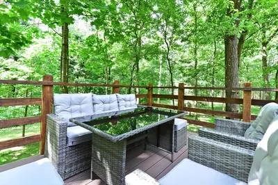 a patio with a table and chairs on a deck at Forest relax in Svedai