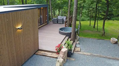 a wooden deck with a picnic table and flowers at Forest relax in Svedai