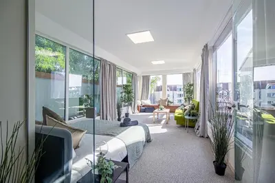 a bedroom with a bed and a living room at The house Kaunas in Kaunas