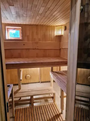 a small sauna with a bench and a window at Atostogų namelis-pirtis Prie upės in Anykščiai