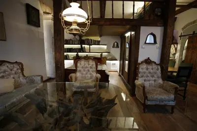 a living room with two chairs and a glass table at Medieval Super Studio in Vilnius