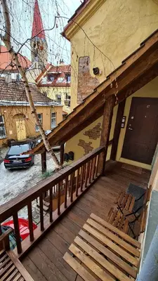a balcony of a house with a car on a street at Medieval Super Studio in Vilnius