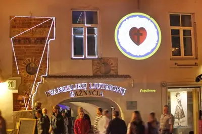 a group of people standing outside of a building at Medieval Super Studio in Vilnius