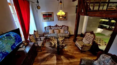 a living room with a couch and a table and chairs at Medieval Super Studio in Vilnius