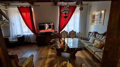 a living room with a couch and a table at Medieval Super Studio in Vilnius