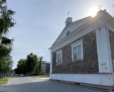 a brick building with a window on a street at S&A apartamentai in Panevėžys