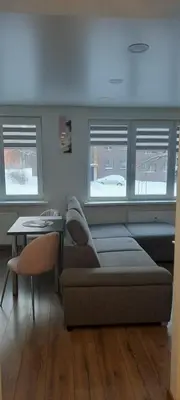 a living room with a couch and a table at Butukas in Anykščiai