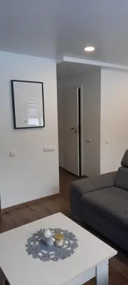 a living room with a couch and a coffee table at Butukas in Anykščiai
