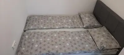a bed with two pillows on it in a room at Butukas in Anykščiai