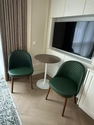 a room with two chairs and a table and a tv at ART Uzupis Apartment in City center in Vilnius