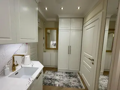 a kitchen with white cabinets and a sink at ART Uzupis Apartment in City center in Vilnius