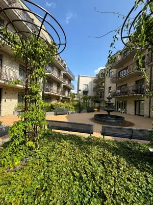a courtyard of an apartment building with a fountain at ART Uzupis Apartment in City center in Vilnius