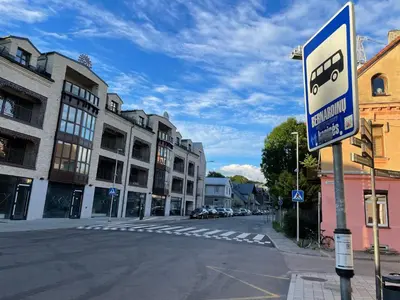 a street with a bus sign on the side of the road at ART Uzupis Apartment in City center in Vilnius