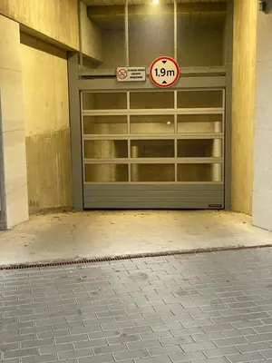 a garage door with a speed limit sign on it at ART Uzupis Apartment in City center in Vilnius