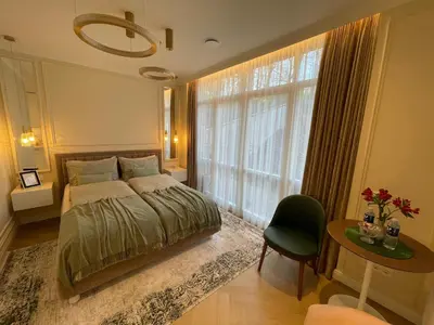 a bedroom with a bed and a large window at ART Uzupis Apartment in City center in Vilnius